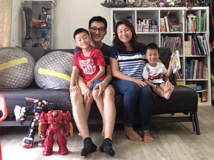 Sam Chew is sitting in a loungeroom with his family.